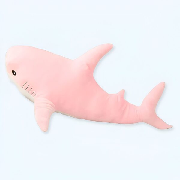 Une peluche rose en forme de requin.