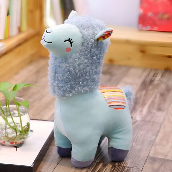 Peluche de lama bleu avec une crinière en fourrure et un motif arc-en-ciel sur le dos.