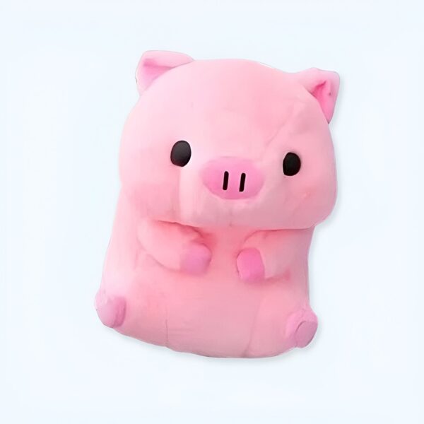 Un cochon en peluche rose assis sur un fond blanc.