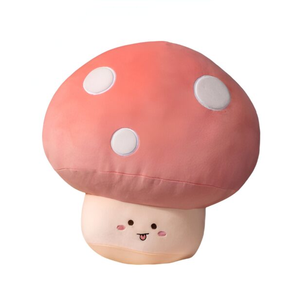 Oreiller en forme de champignon rose avec des points blancs et un visage souriant.