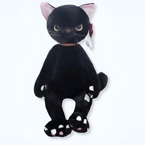 Peluche de chat noir avec des yeux jaunes et des coussinets roses.