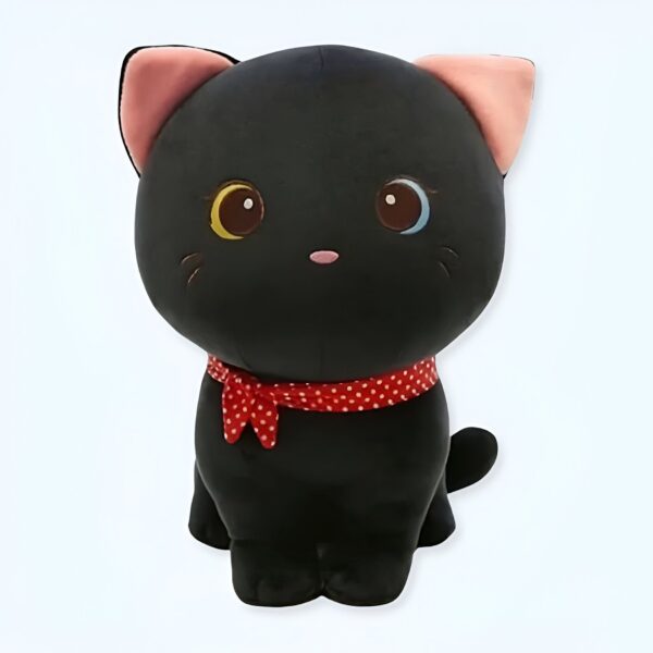 Peluche de chat noir avec un nœud rouge à pois blancs.