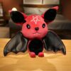 Une adorable peluche de chauve-souris rouge avec des ailes noires, une étoile à cinq branches sur le front et de petits crocs.