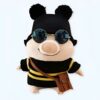 peluche-cochon-a-lunettes-et-pull-abeille-1a-3 Un cochon en peluche portant des lunettes de soleil et un chapeau noir avec des rayures jaunes et une sacoche marron.