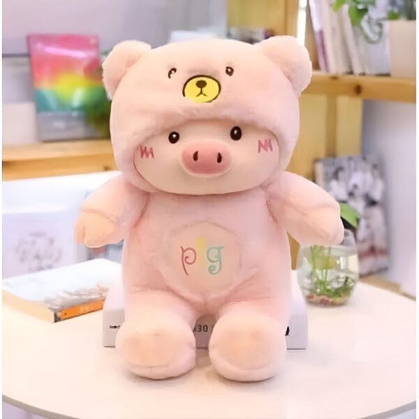 peluche-cochon-deguise-en-ours-jouet-doux-et-moelleux-pour-enfant-2a Une peluche rose en forme de cochon avec un chapeau de ours.
