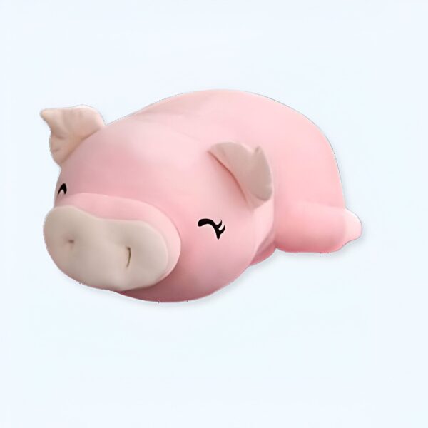Une peluche rose en forme de cochon avec des yeux noirs souriants.