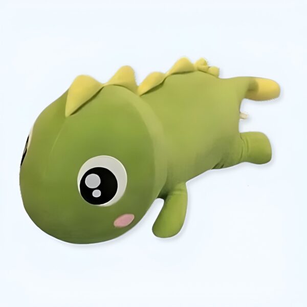 Peluche de dinosaure vert avec de grands yeux noirs et une petite bouche rose.