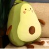 Un oreiller en forme d'avocat souriant avec un noyau brun.