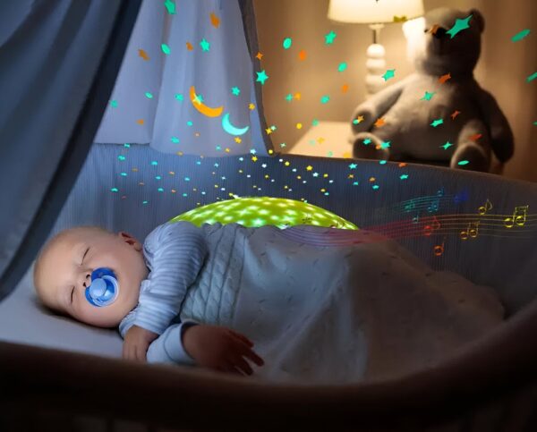 Un bébé dort paisiblement dans un lit bébé avec une veilleuse projetant des étoiles et des notes de musique sur le plafond.