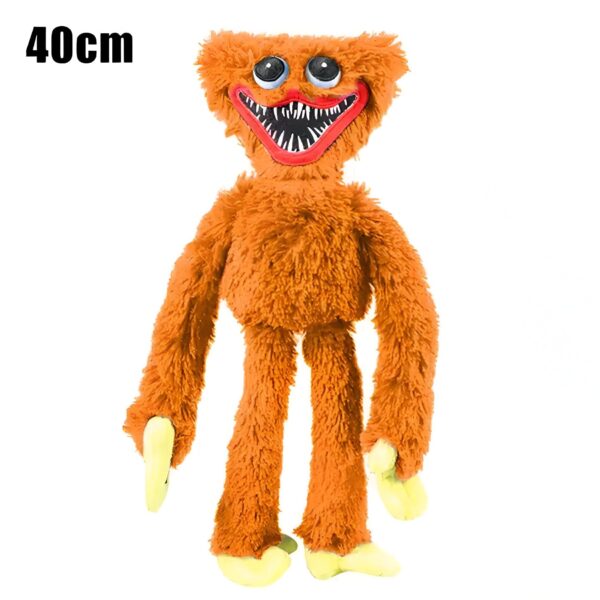 Peluche orange effrayant avec un grand sourire et des yeux blancs.