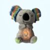 Une peluche de koala grise avec des oreilles multicolores qui s'allume. La peluche est faite de fourrure douce et a une expression faciale endormie.