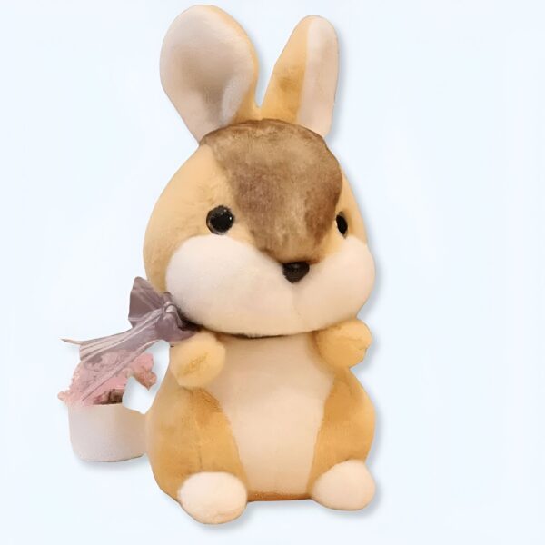 Une adorable peluche de lapin avec un nœud rose et blanc, parfaite pour les enfants.