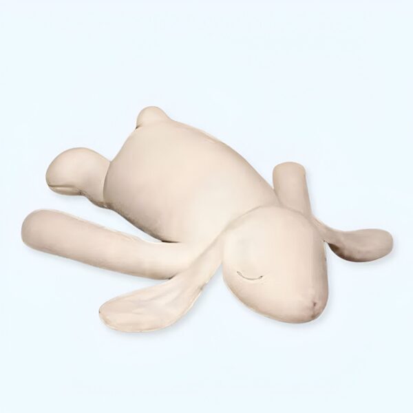 Un lapin en peluche blanc couché sur le dos avec les yeux fermés.