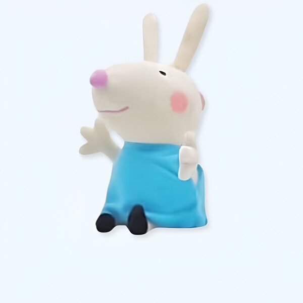Une figurine de lapin blanc portant une robe bleue.