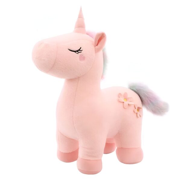 peluche-licorne-magique-douce-cadeau-enfant-2a-5 Une licorne en peluche rose avec une corne dorée, des yeux fermés, des fleurs sur le côté et une queue arc-en-ciel.