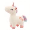 peluche-licorne-magique-douce-cadeau-enfant-6a-1 Une peluche de licorne blanche avec une crinière arc-en-ciel, des fleurs roses et un petit cœur sur le visage.