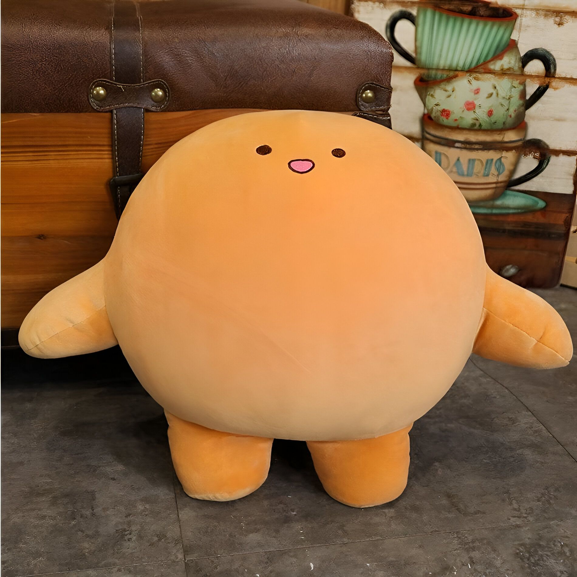 Peluche morbido e rotondo di colore arancione, perfetto per coccole e regali.