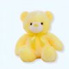 peluche-ours-lumineux-jaune-ami-calin-pour-enfant-1a-1 Un ours en peluche jaune assis avec un nœud jaune.