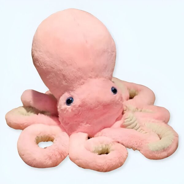 Une grosse peluche rose en forme de pieuvre avec des yeux bleus.