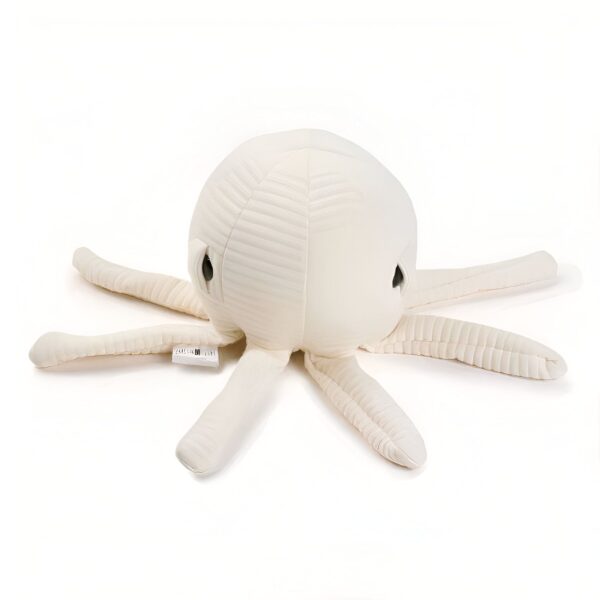 Une peluche de poulpe blanc cassé avec des yeux noirs.