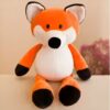 peluche-renard-a-croquer-3a-2 Peluche renard orange avec un ventre blanc et des pattes noires assis sur une table.