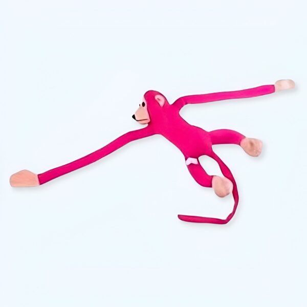Un singe rose en peluche avec de longs bras et des jambes.