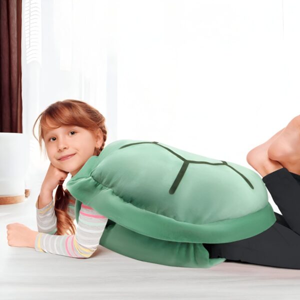 Une jeune fille souriante allongée sur le ventre, portant un costume de Tortank.