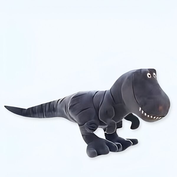 Un dinosaure en peluche gris souriant avec de grands yeux.