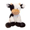 Une vache en peluche noire et blanche avec un sourire est assise sur un fond blanc.