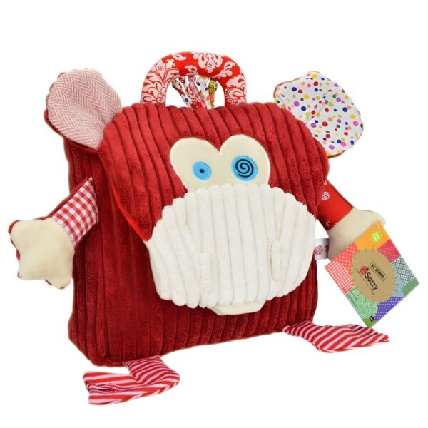 Sac à dos en peluche rouge en forme de singe avec des détails multicolores.